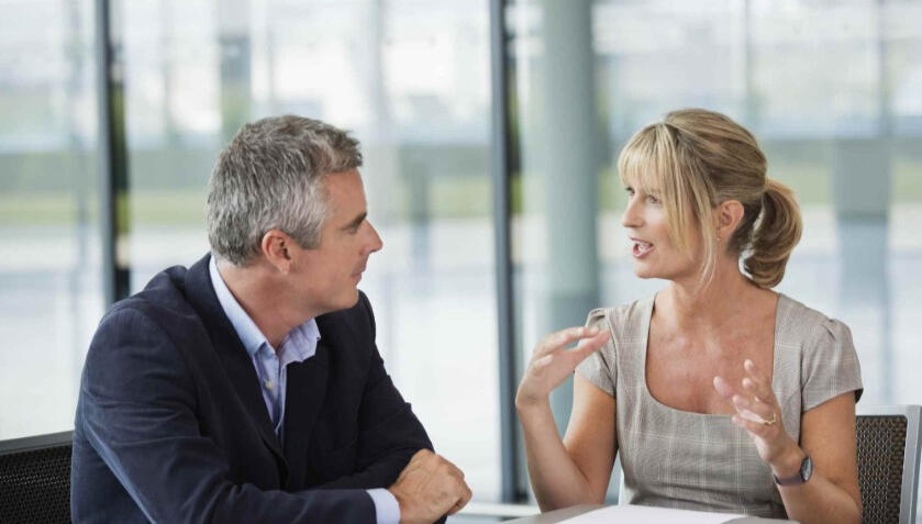 Private Executive Advisory Session Advisor and executive in a confidential one-to-one meeting discussing critical business decisions.